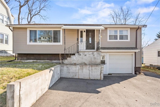 view of front of house featuring aphalt driveway and an attached garage