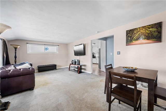 living room with baseboards and light colored carpet