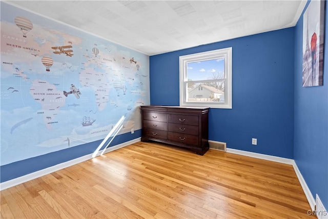 unfurnished bedroom with light wood-style flooring, baseboards, and visible vents