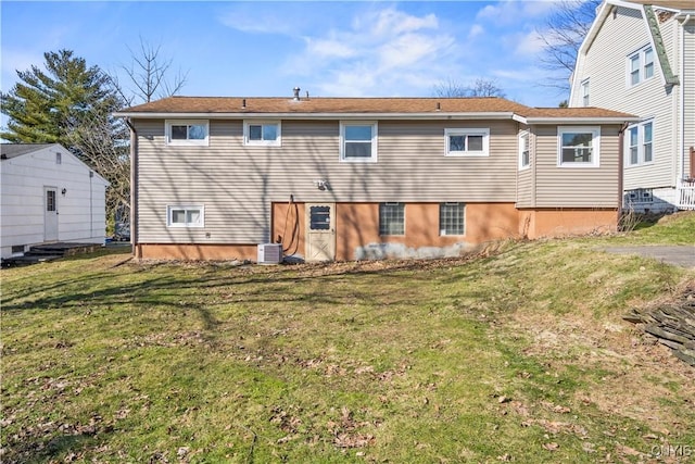 rear view of property with a lawn and central AC