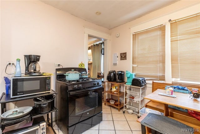 kitchen with light tile patterned floors and black appliances