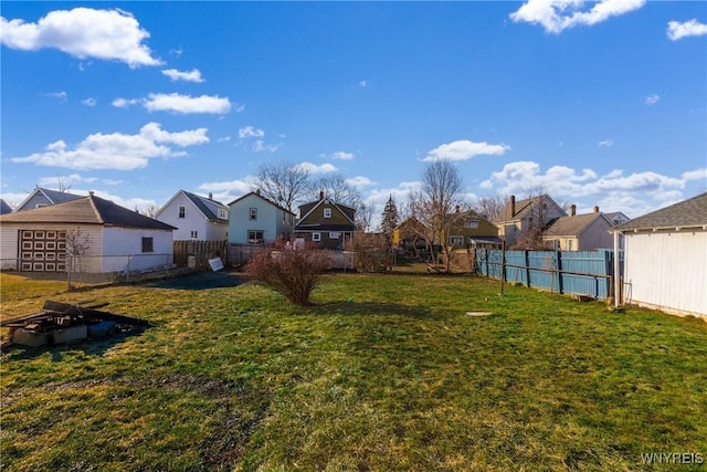 view of yard featuring a residential view and fence