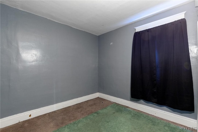 carpeted empty room with baseboards