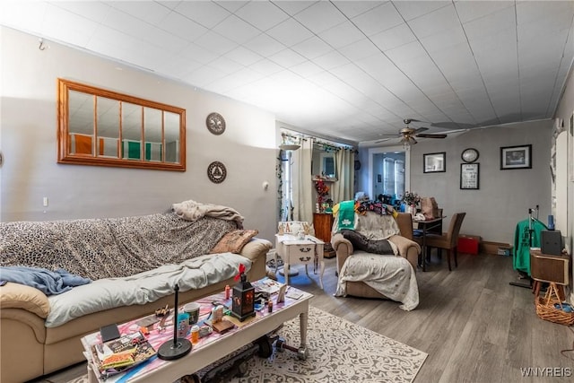 living room with a ceiling fan and wood finished floors