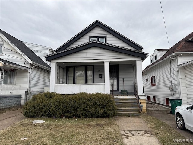 view of front of home with cooling unit and a porch