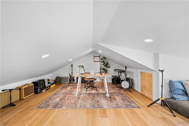 office space featuring vaulted ceiling and wood finished floors