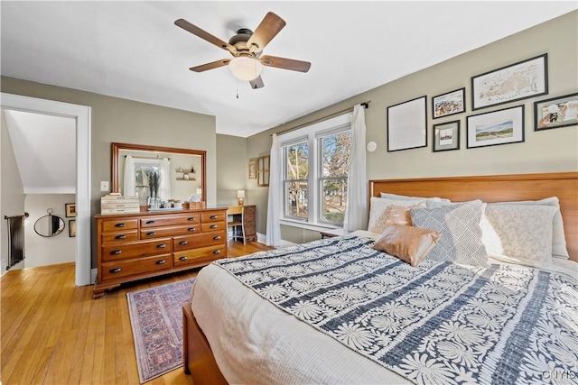 bedroom with baseboards, wood-type flooring, and ceiling fan