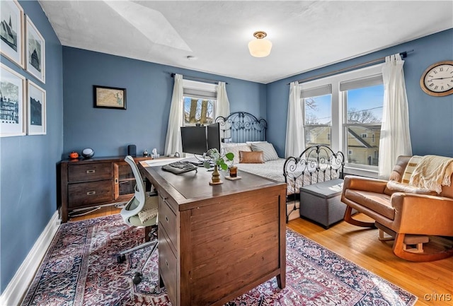 office space featuring baseboards and wood finished floors