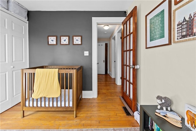 bedroom featuring baseboards and wood finished floors