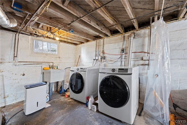 laundry room featuring a sink, independent washer and dryer, and laundry area