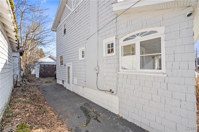 view of side of property featuring an outbuilding