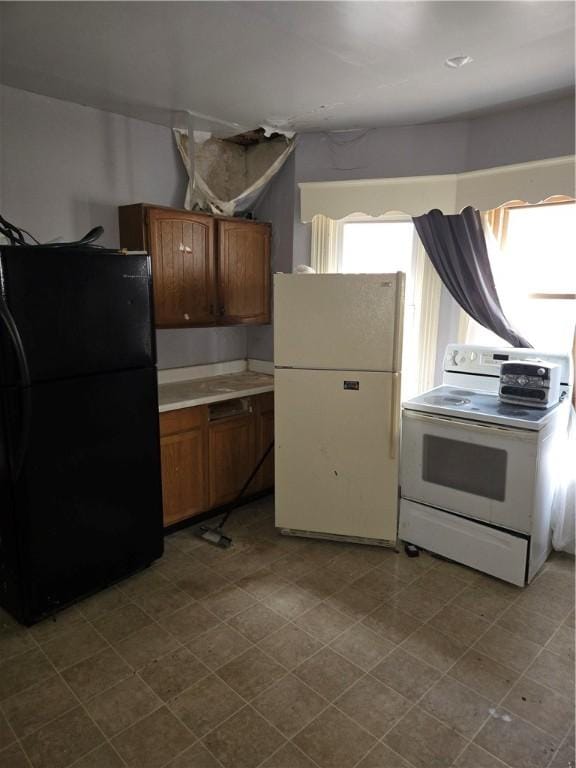 kitchen featuring white appliances and brown cabinetry