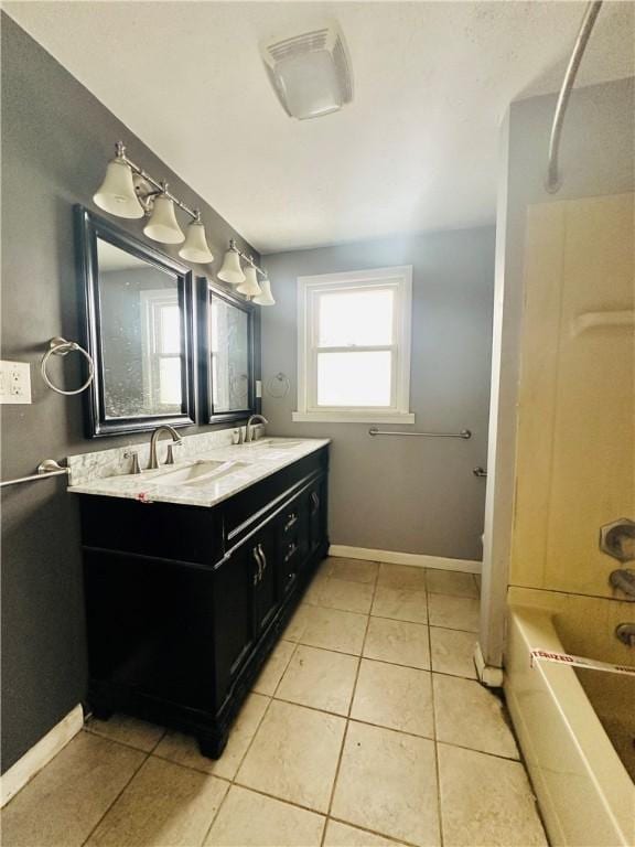 full bath with tile patterned floors, a sink, shower / tub combination, double vanity, and baseboards