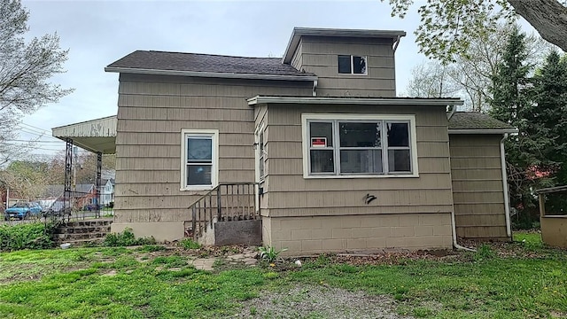 13 E Albion St, Murray, NY 14470 - view of side of home featuring a lawn and a shingled roof