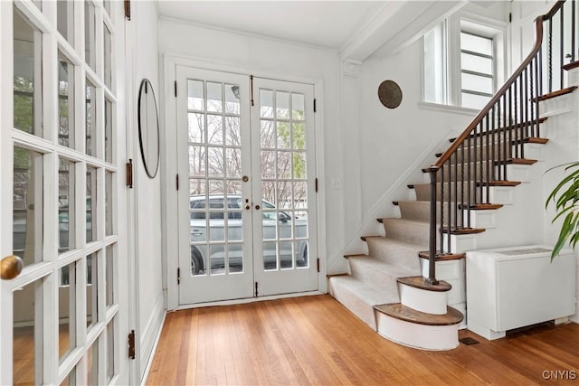 foyer entrance with french doors, hardwood / wood-style floors, and stairs