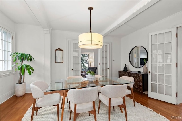 dining room featuring beam ceiling, french doors, baseboards, and wood finished floors