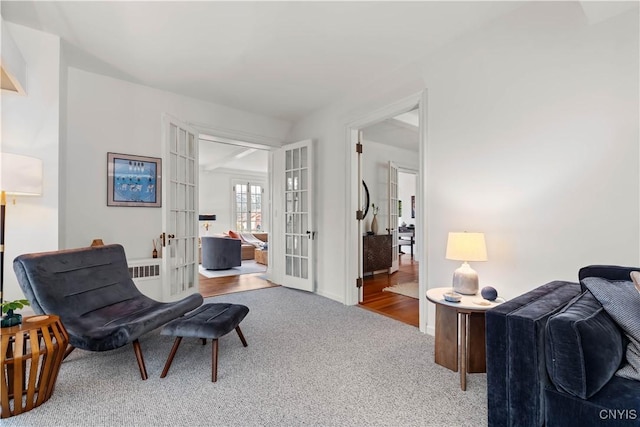 sitting room featuring carpet flooring and french doors