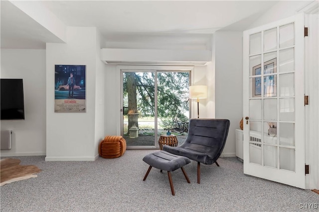 sitting room with carpet and baseboards