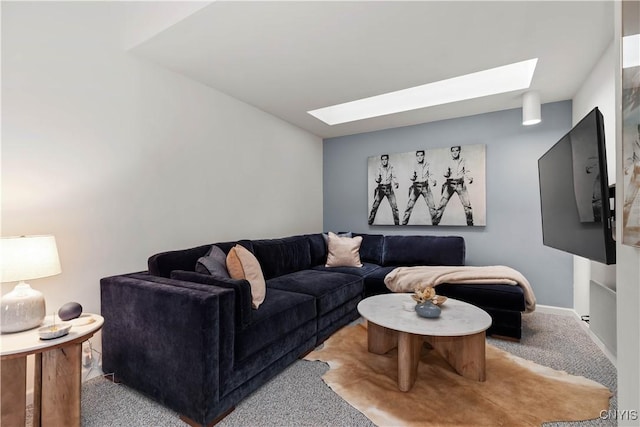 living area with light carpet, a skylight, and baseboards