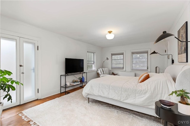 bedroom with baseboards and wood finished floors