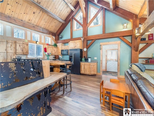 interior space with beam ceiling, high vaulted ceiling, wooden ceiling, and hardwood / wood-style flooring