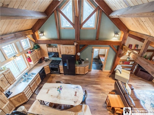 interior space with dark wood finished floors, beam ceiling, wood ceiling, and a wealth of natural light