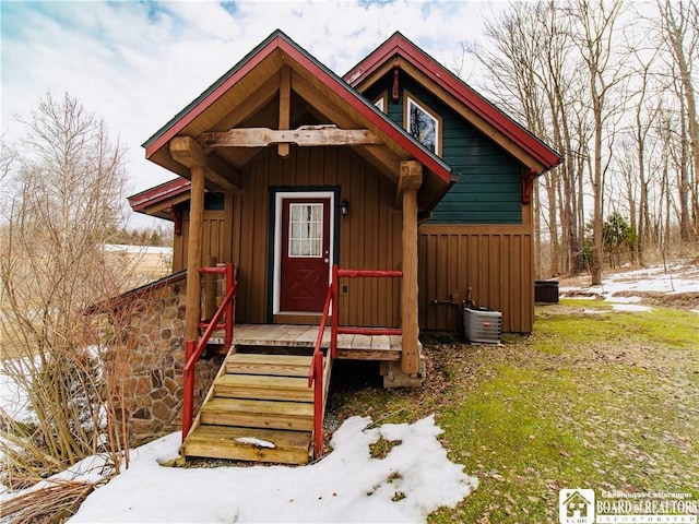 rustic home featuring board and batten siding and central AC