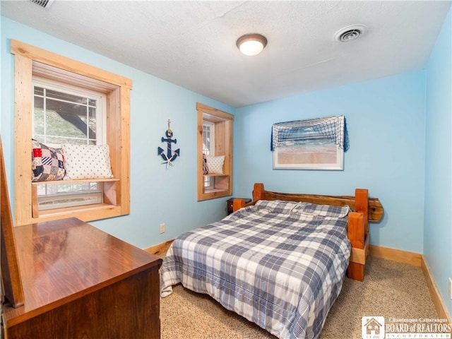 bedroom with visible vents, baseboards, and light colored carpet