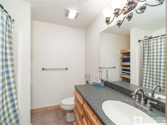 full bath featuring tile patterned floors, a textured ceiling, toilet, and vanity