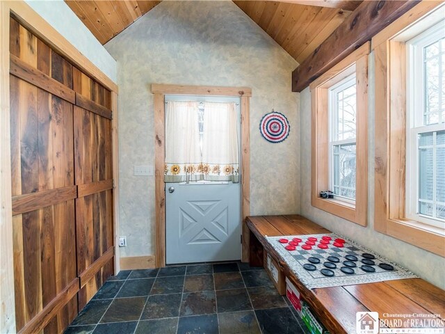 interior space with stone finish floor, wooden ceiling, and lofted ceiling