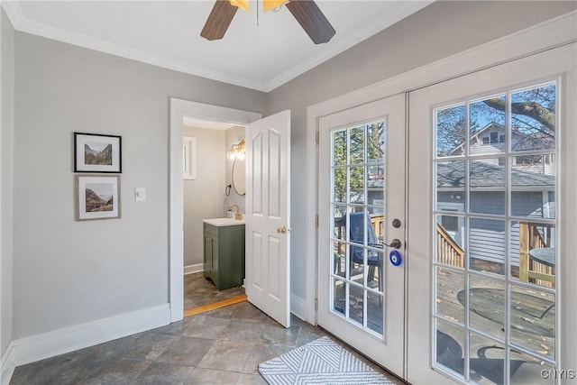 doorway featuring a sink, french doors, baseboards, and ornamental molding