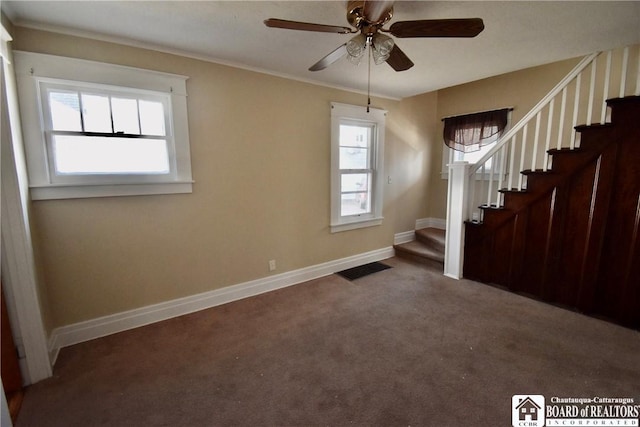 interior space featuring carpet flooring, plenty of natural light, and stairs