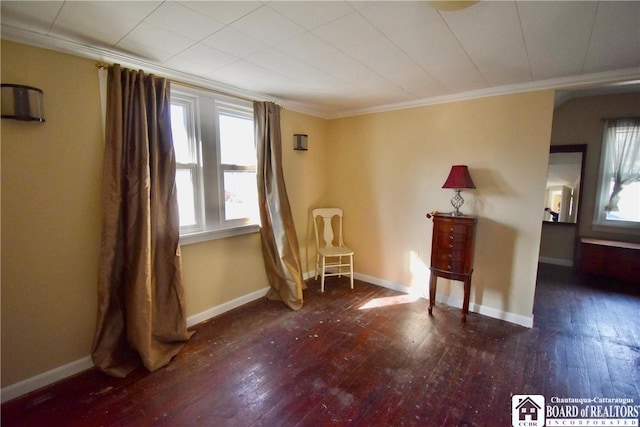 unfurnished room with crown molding, hardwood / wood-style flooring, and baseboards