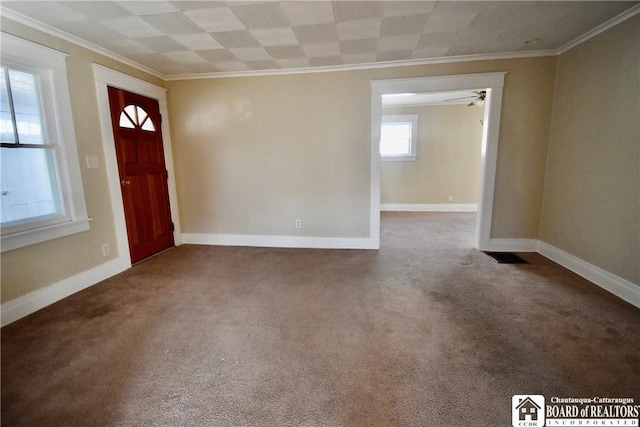 entrance foyer with carpet flooring, baseboards, and ornamental molding