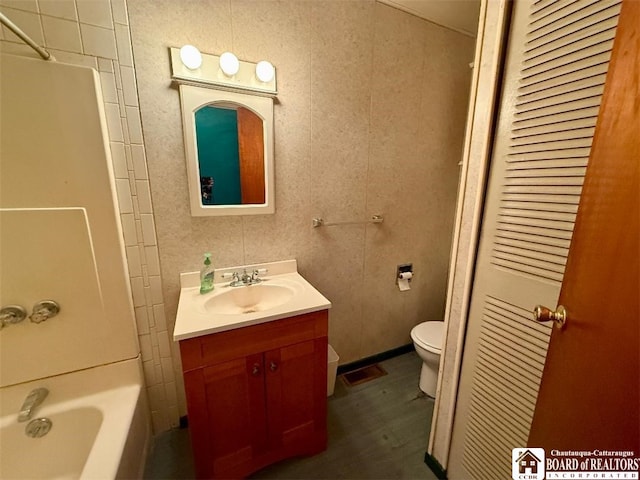 bathroom featuring shower / bathing tub combination, toilet, and vanity