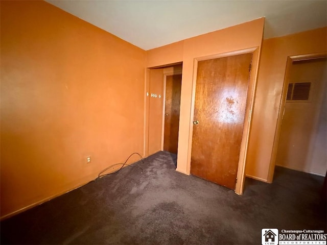 unfurnished bedroom featuring visible vents and carpet floors