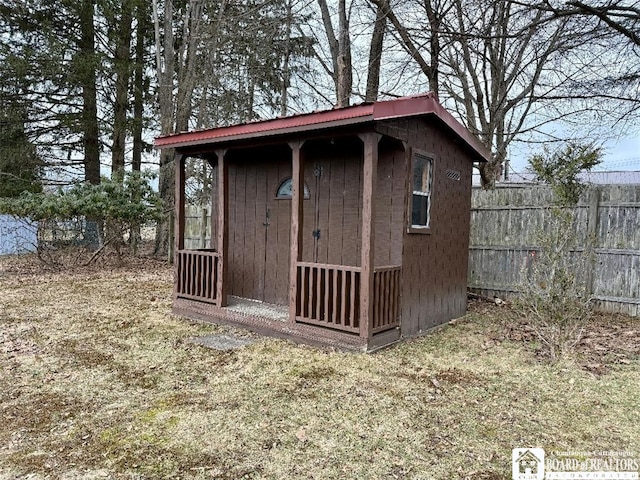 view of shed featuring fence