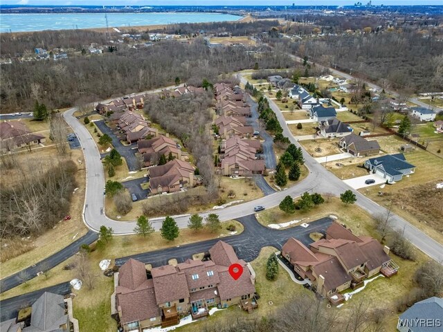 drone / aerial view featuring a residential view and a water view