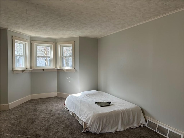 unfurnished bedroom with visible vents, baseboards, and carpet floors