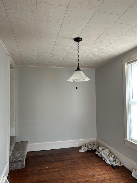 interior space with stairway, wood finished floors, and baseboards