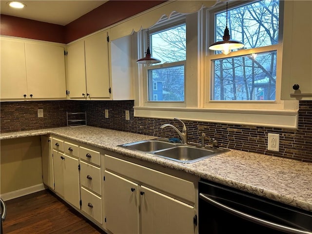 kitchen featuring dark wood-style floors, a sink, decorative backsplash, light countertops, and dishwasher