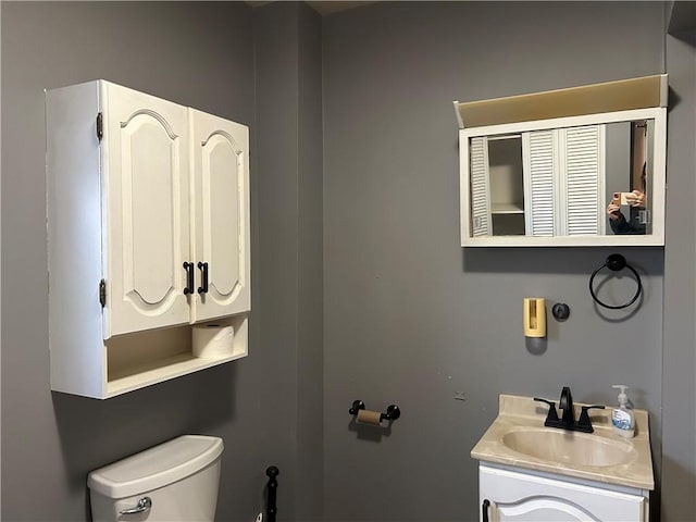 bathroom featuring toilet and vanity