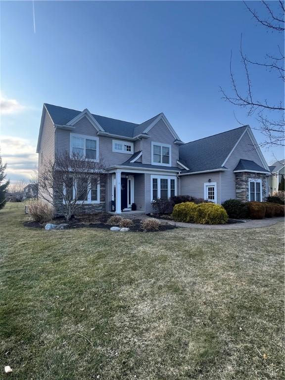 view of front of house featuring a front lawn and stone siding