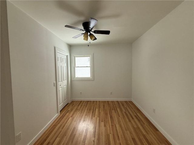 unfurnished room with light wood-style flooring, baseboards, and ceiling fan