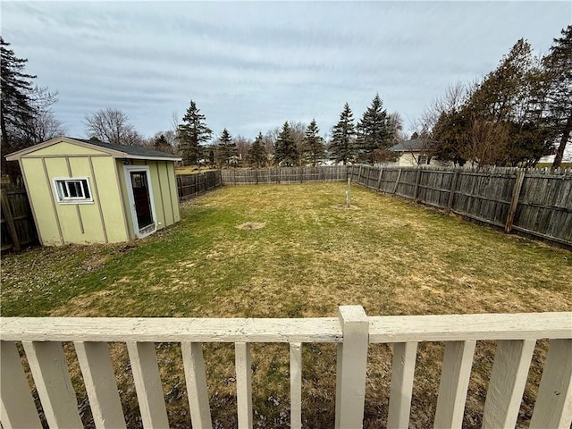 view of yard with an outdoor structure, a storage unit, and a fenced backyard