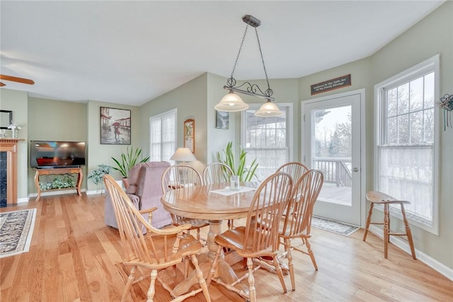 dining room with baseboards and light wood-style floors