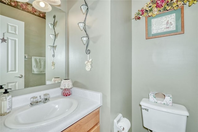 bathroom featuring toilet and vanity