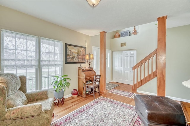 entrance foyer with baseboards, wood finished floors, and stairs