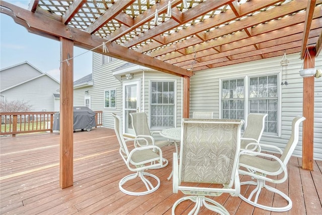 wooden terrace with a grill and a pergola