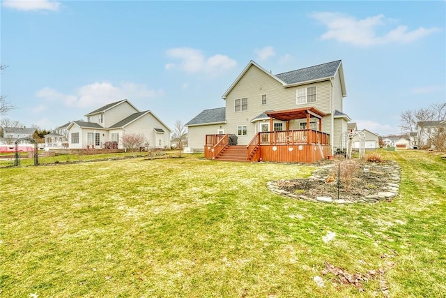 back of house with a lawn and a wooden deck